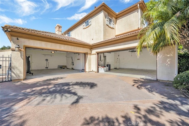 2117 Brittany Park Rd, Camarillo, CA 93012 - back of property with driveway, stucco siding, and a chimney