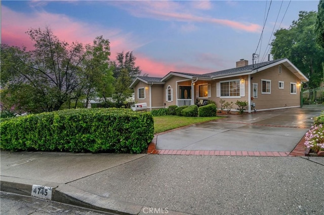 4745 Dunsmore Ave, La Crescenta, CA 91214 - ranch-style house with concrete driveway, covered porch, and a chimney