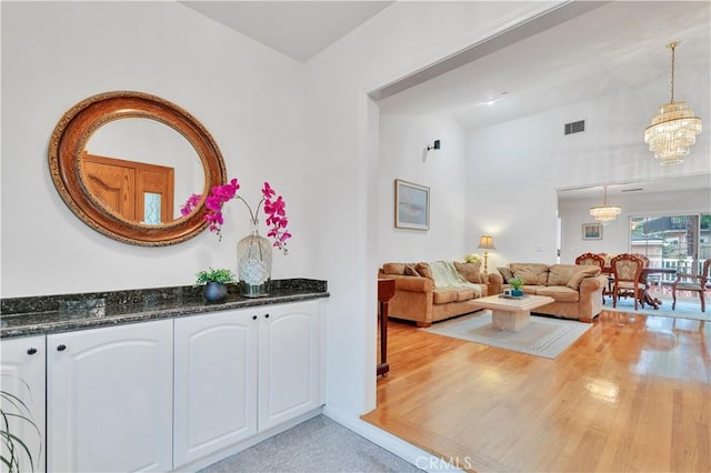 living area with a chandelier and light wood-style flooring