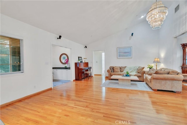 4745 Dunsmore Ave, La Crescenta, CA 91214 - living room with wood finished floors, a chandelier, high vaulted ceiling, and baseboards