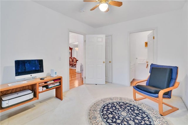 living area with a ceiling fan and carpet flooring