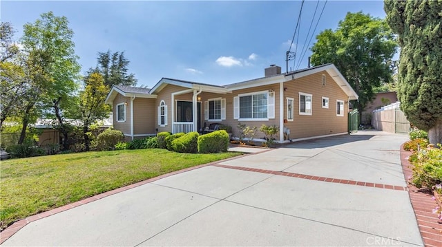 4745 Dunsmore Ave, La Crescenta, CA 91214 - ranch-style home with concrete driveway, a chimney, and a porch