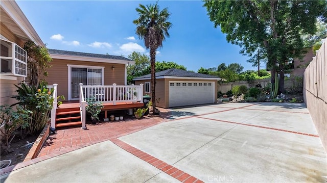 4745 Dunsmore Ave, La Crescenta, CA 91214 - view of front facade with a wooden deck, an outbuilding, a garage, and driveway
