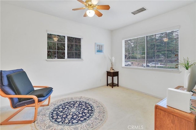 sitting room with ceiling fan, carpet flooring, and baseboards
