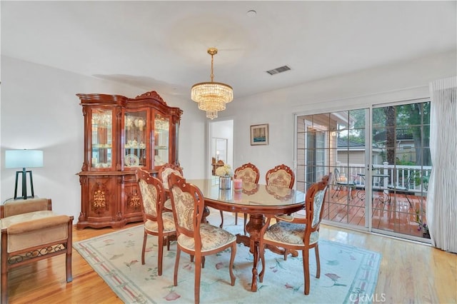 dining space with a chandelier and light wood finished floors