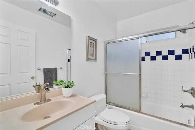 full bathroom with vanity, toilet, and enclosed tub / shower combo
