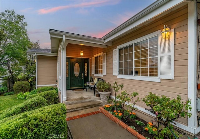 doorway to property featuring covered porch