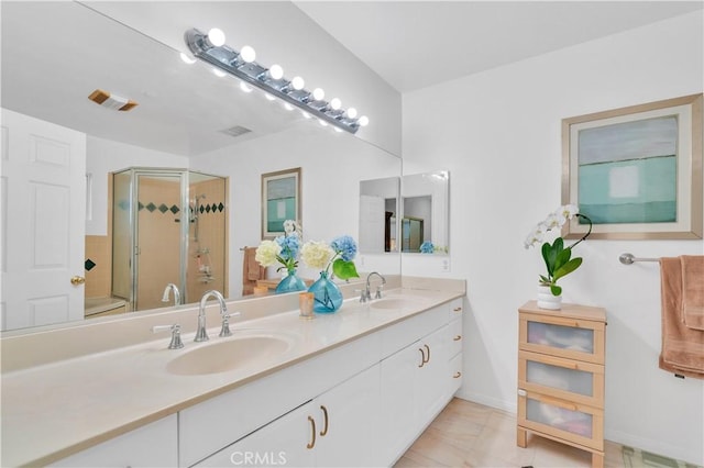full bath with a stall shower, double vanity, and baseboards