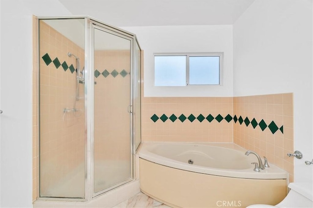 bathroom featuring a shower stall, a garden tub, marble finish floors, and toilet
