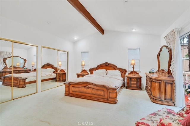 bedroom with multiple closets and carpet floors