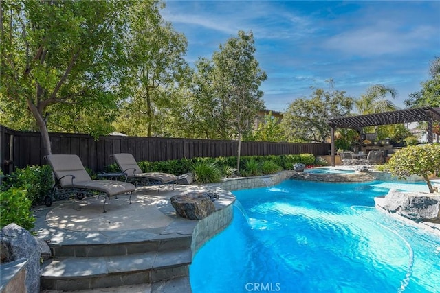 view of pool featuring a fenced backyard, a patio, and a pool with connected hot tub