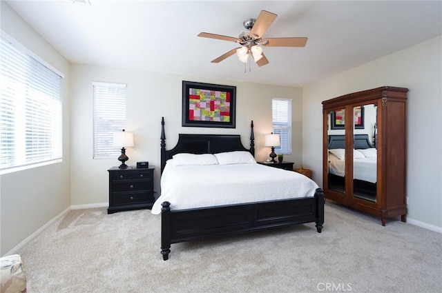 bedroom with light carpet, baseboards, and ceiling fan
