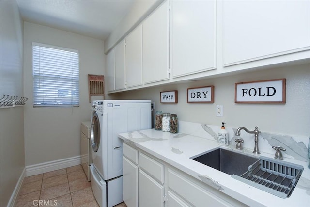 washroom with washing machine and clothes dryer, cabinet space, baseboards, and light tile patterned floors