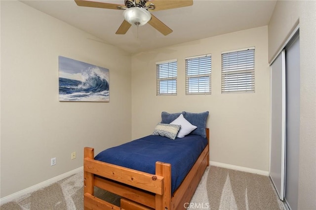 carpeted bedroom with baseboards, a ceiling fan, and a closet