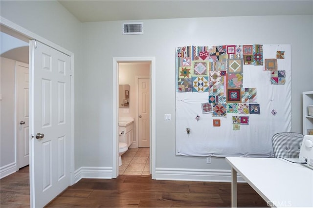 home office featuring wood finished floors and baseboards