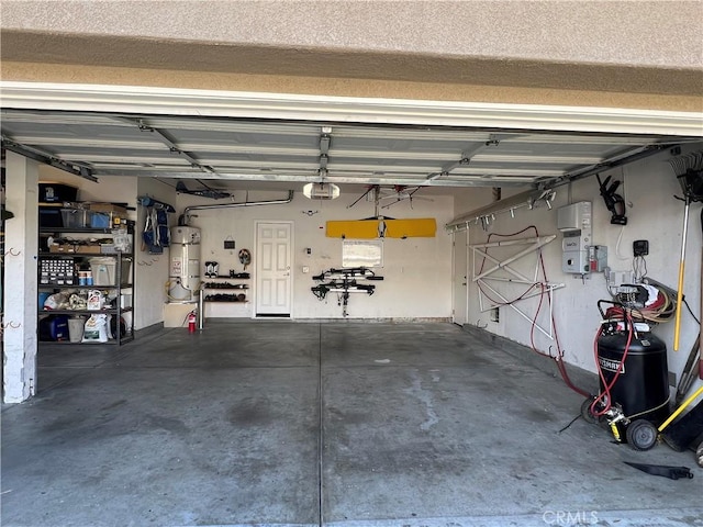 garage with a garage door opener and water heater