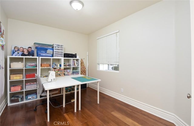 recreation room featuring baseboards, wood finished floors, and a desk