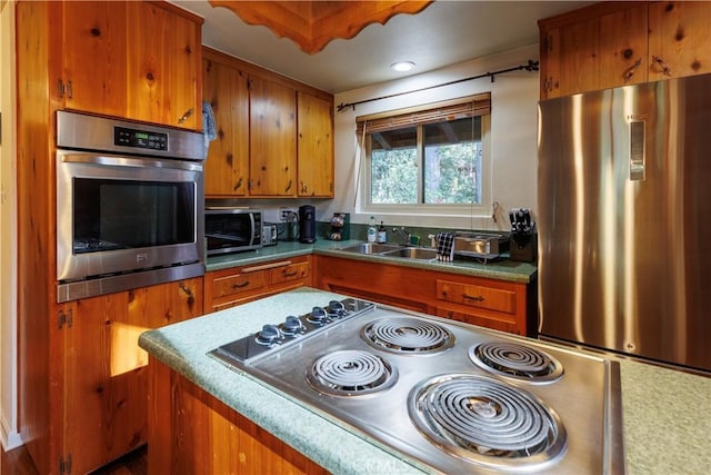 26220 Pine Dell Rd, Idyllwild, CA 92549 - kitchen with stainless steel appliances, brown cabinets, a sink, and light countertops