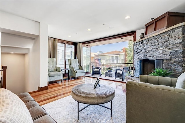 436 32nd St, Manhattan Beach, CA 90266 - living area with light wood-type flooring, healthy amount of natural light, a wall of windows, and a fireplace