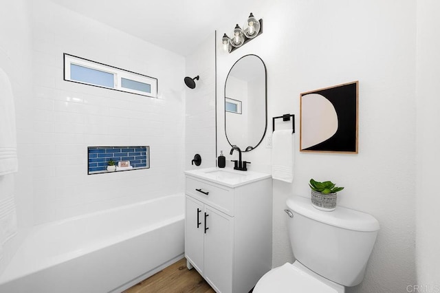 full bathroom featuring toilet, vanity, wood finished floors, and  shower combination