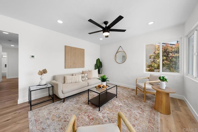living area with ceiling fan, baseboards, wood finished floors, and recessed lighting