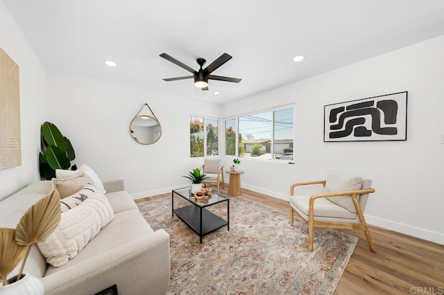 living room featuring baseboards, recessed lighting, wood finished floors, and a ceiling fan