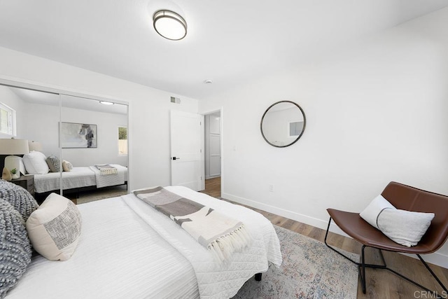 bedroom featuring wood finished floors and baseboards
