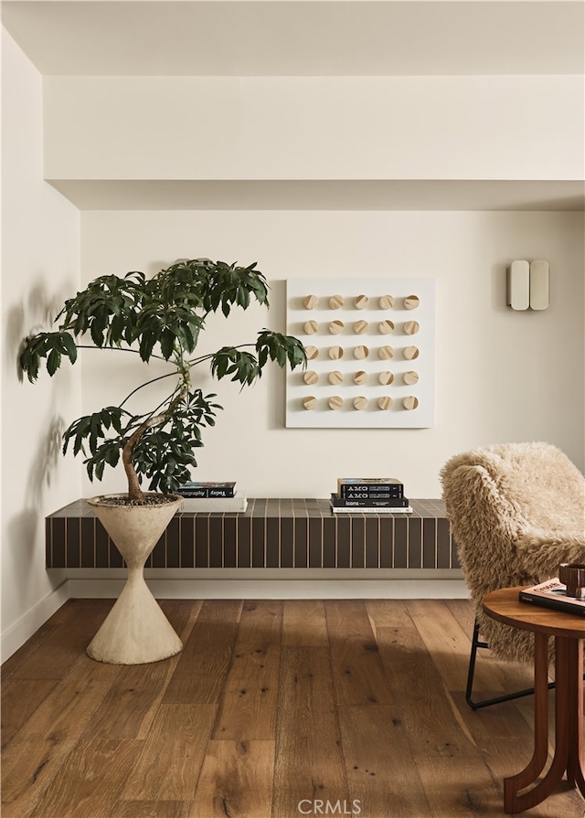 living area featuring hardwood / wood-style floors and baseboards