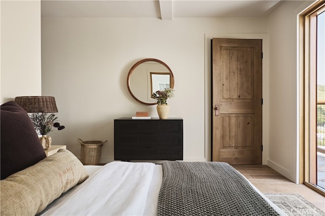 bedroom with light wood-type flooring, access to exterior, and baseboards