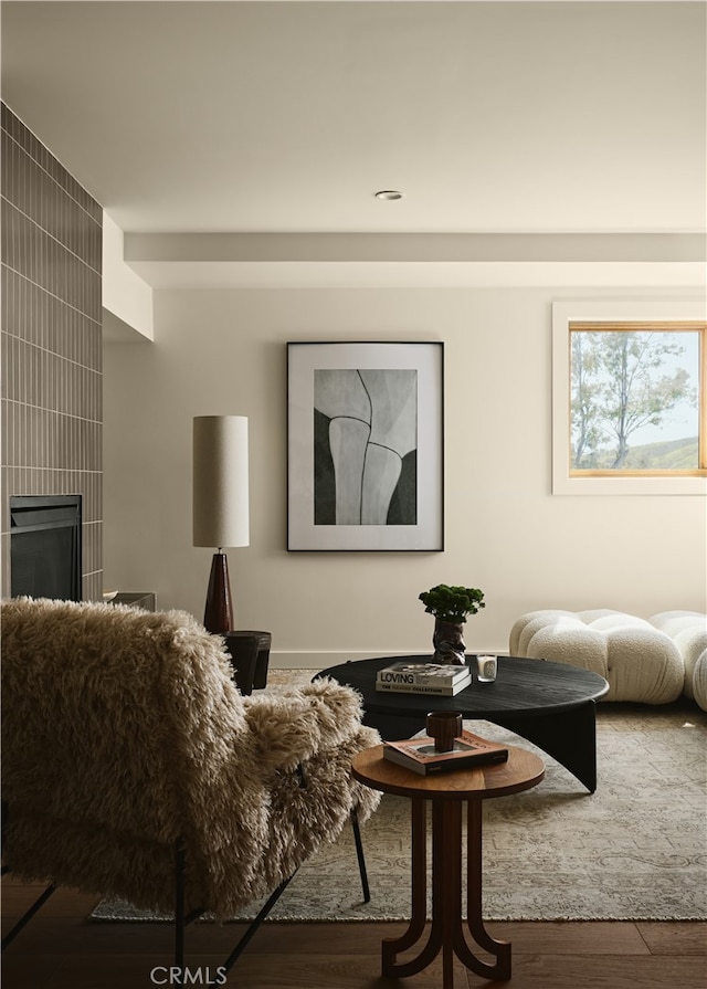 living area with wood finished floors and a fireplace