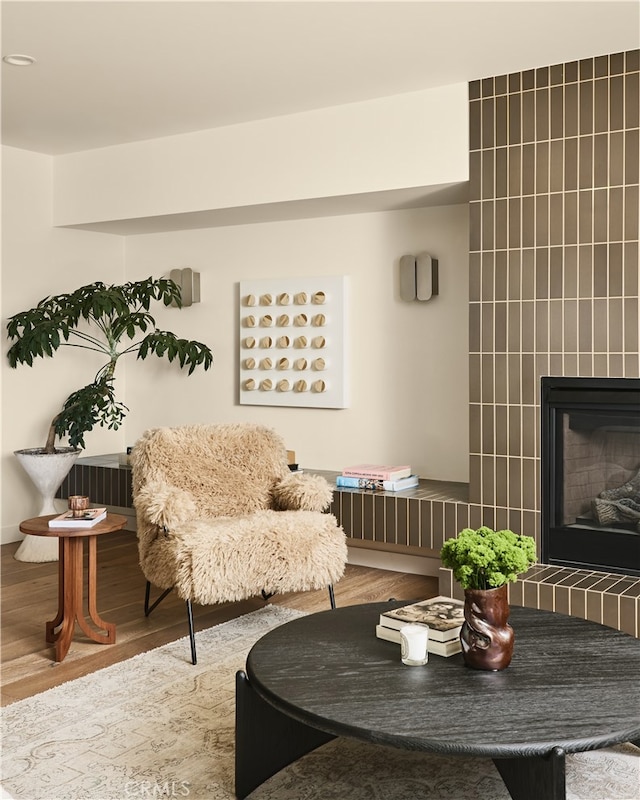 living area with wood finished floors and a fireplace