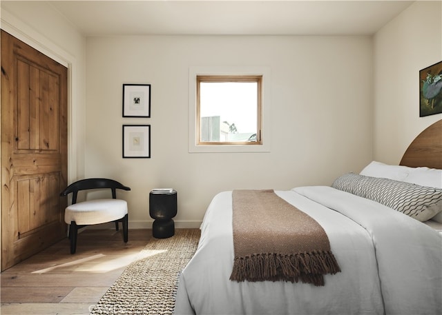 bedroom featuring wood finished floors and baseboards