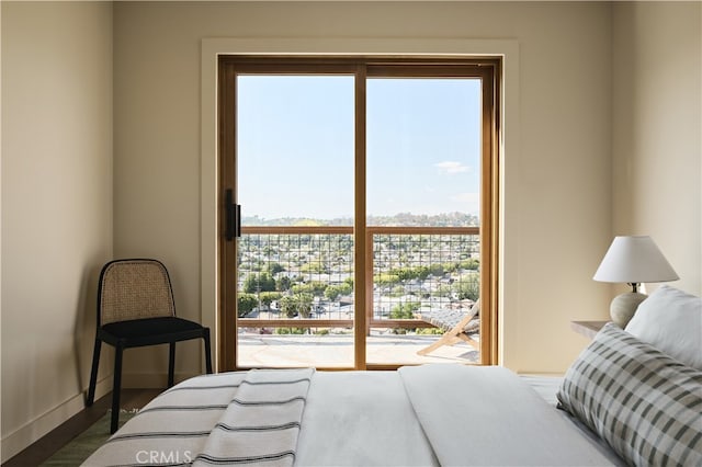 bedroom featuring dark wood-style flooring and baseboards