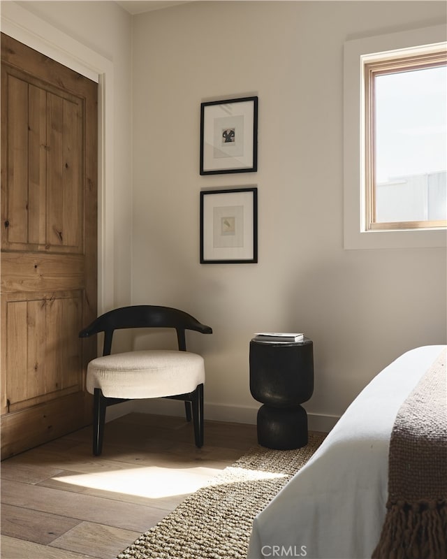 bedroom featuring baseboards and wood finished floors