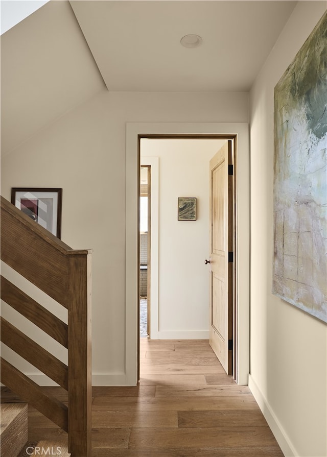 hall featuring wood finished floors and baseboards