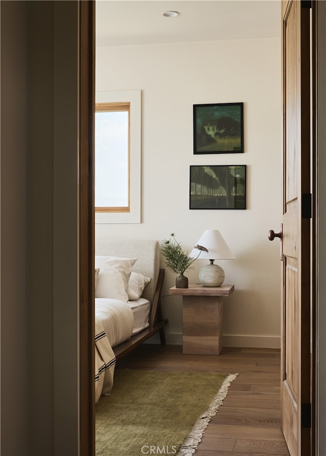 bedroom with wood finished floors and baseboards