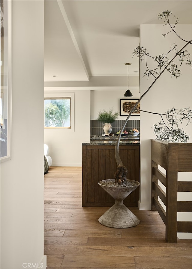 hallway with light wood finished floors and baseboards
