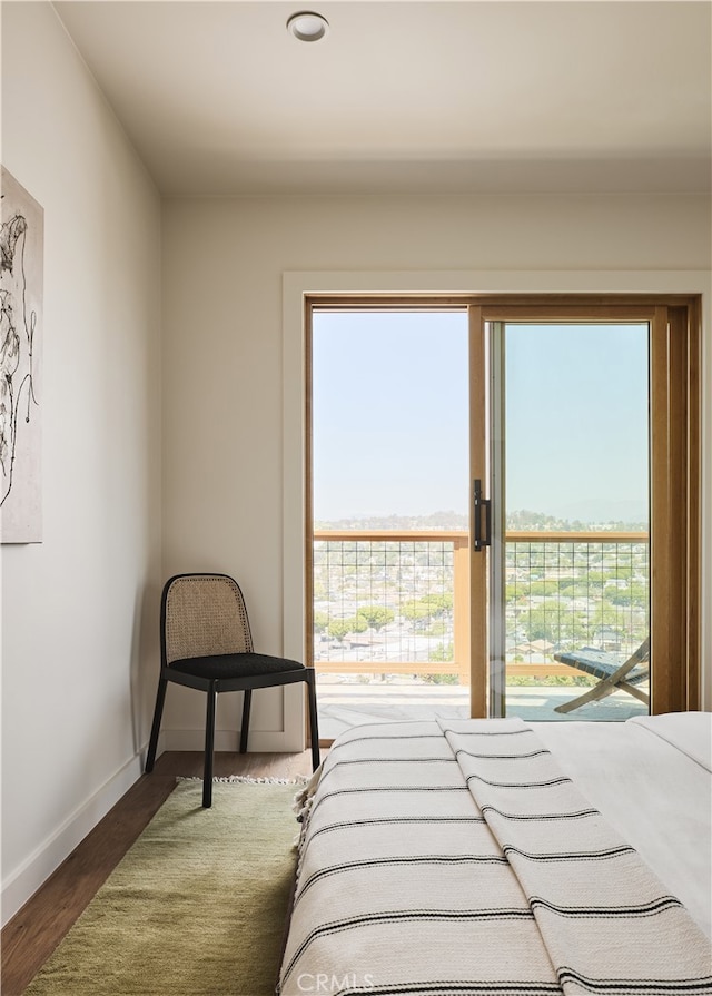 bedroom featuring baseboards and wood finished floors