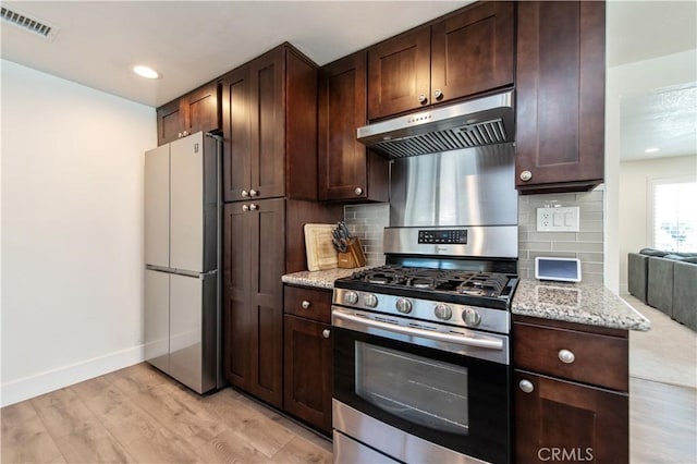 1263 Sandra Ct, Upland, CA 91786 - kitchen with freestanding refrigerator, stainless steel range with gas stovetop, under cabinet range hood, backsplash, and recessed lighting