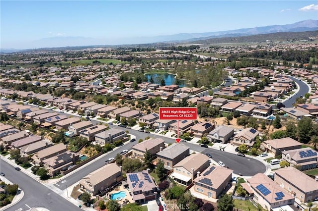 view of property location featuring nearby suburban area and a water and mountain view