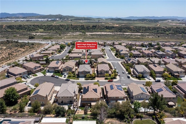 aerial view of residential area featuring mountains