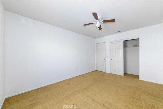 unfurnished bedroom with light carpet, ceiling fan, and baseboards
