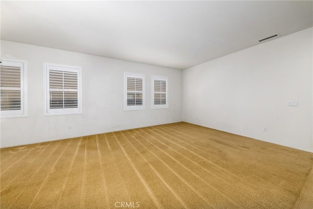 empty room featuring light colored carpet