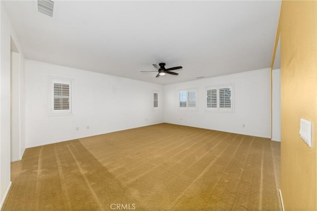 carpeted spare room with ceiling fan