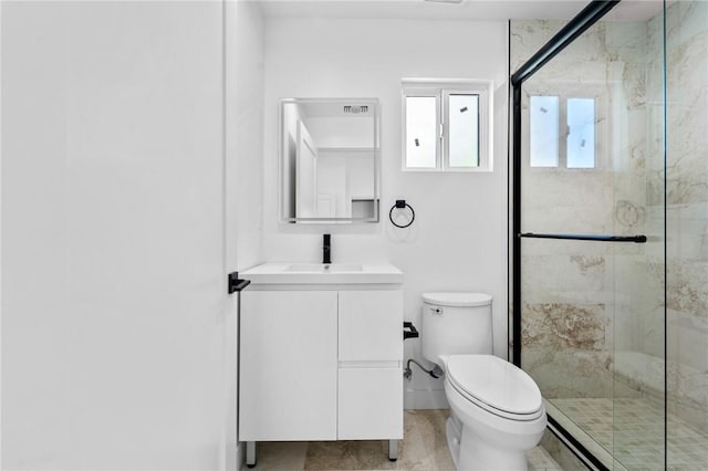 full bathroom featuring a shower stall, toilet, and vanity