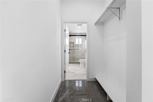 walk in closet featuring marble tiled floors