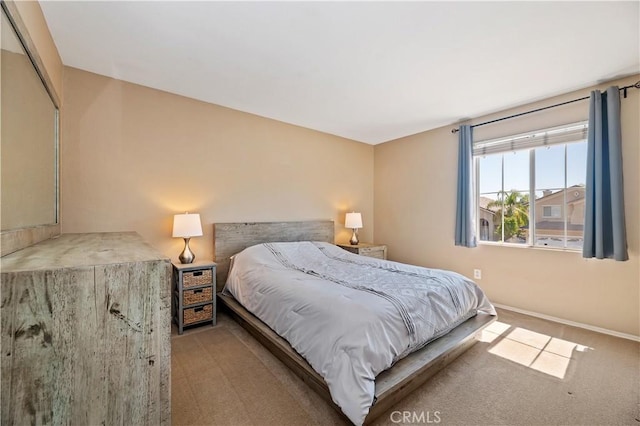 bedroom featuring baseboards and carpet floors
