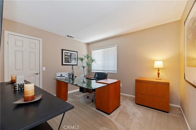 office space featuring baseboards and light colored carpet