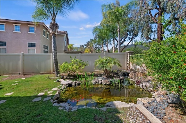 view of yard featuring a garden pond