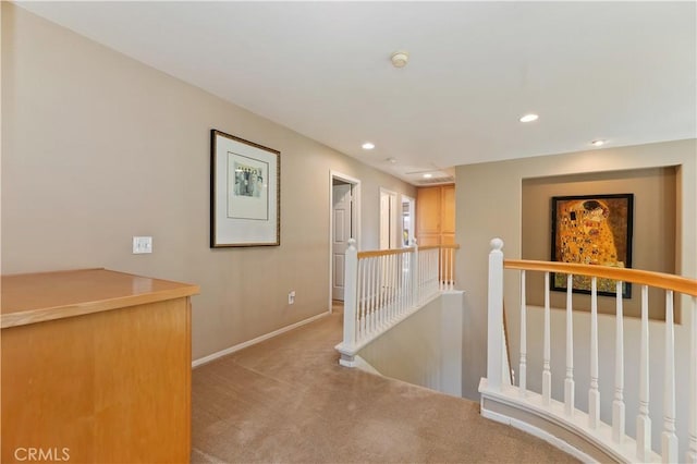 hallway with an upstairs landing, carpet flooring, recessed lighting, and baseboards
